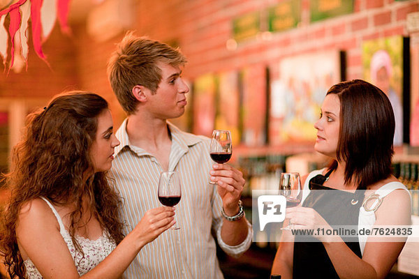 Server and customers tasting wine