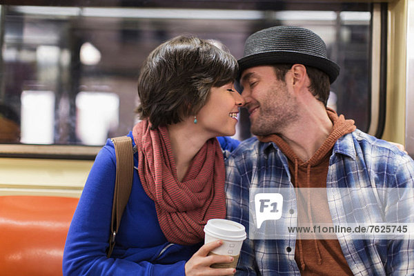 Couple kissing on urban subway