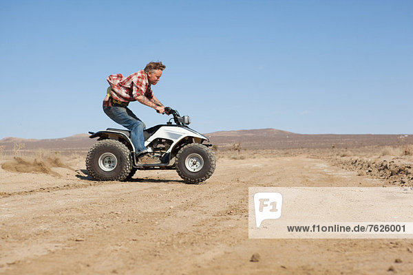 Man riding four-wheeler in desert