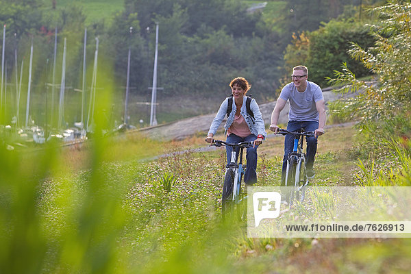 Couple on a bike trip at Sorpe Dam  Sauerland  Germany