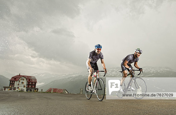 Two racing cyclists on mountain pass road  Andermatt  Switzerland