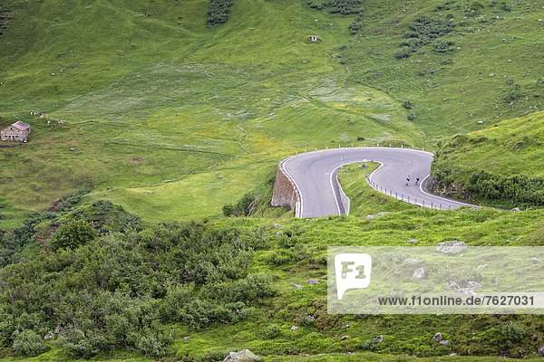 Two racing cyclists on mountain pass road  Andermatt  Switzerland