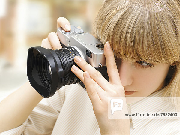 Woman taking a photograph with a camera