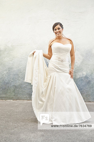 Hispanic bride in wedding dress