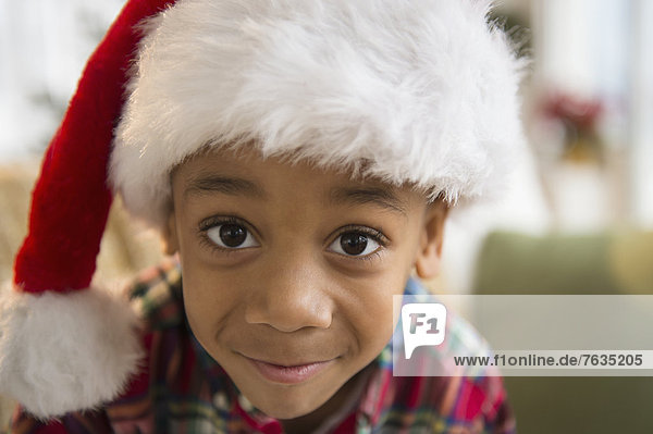 African American boy wearing Santa hat