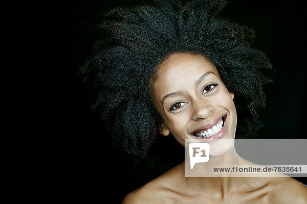 Nude mixed race woman smiling