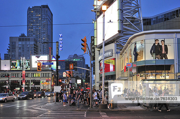Canada  Dundas Yonge Square  Ontario  Toronto  crosswalk  crowd  dark  dusk  night  people  shopping  shops  sidewalk  sundown