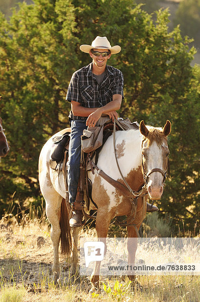 Pacific Northwest  Oregon  USA  United States  America  cowboy  riding  horseback  sport  horse  ranch  dude  range  portrait  laughing  face  friendly  smile  hat