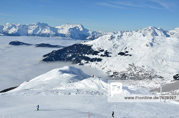 the famous winter ski resort of Verbier in the Swiss Alps. In the background The Dents du Midi  in the foreground skiers and fresh snow.
