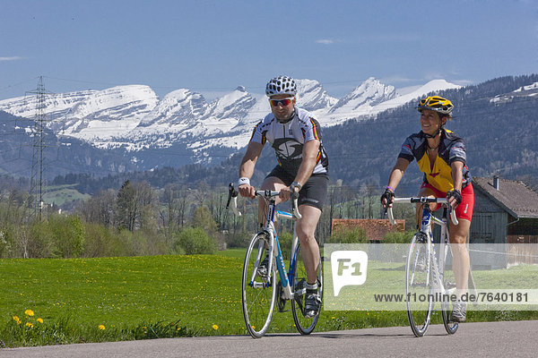 Cyclist  biker  Toggenburg  spring  bicycle  bicycles  bike  riding a bicycle  canton  SG  St. Gallen  Churfirsten  racing bicycle  Switzerland  Europe  couple  man  woman  Wattwil