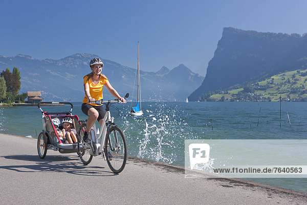 Family  electric bicycles  Flyer  eBike  Bürgenstock  bicycle  bicycles  bike  riding a bicycle  town  city  lake  lakes  canton  LU  Lucerne  Luzern  Vierwaldstättersee  lake Lucene  central Switzerland  Switzerland  Europe  bicycle  bike  woman  children  followers