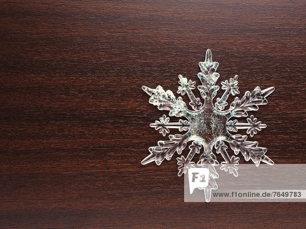 Snowflake on a wooden background  Christmas decoration