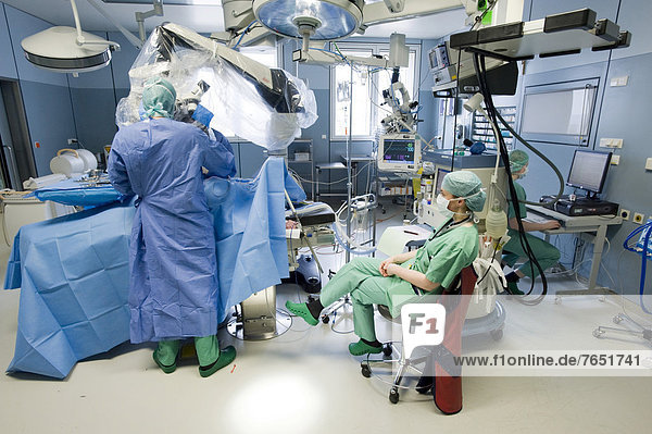 Anaesthetist monitoring a spinal surgery with a neurosurgeon in an operating room  Oberschwaben Klinik St. Elisabeth Hospital  Ravensburg  Baden-Wuerttemberg  Germany  Europe
