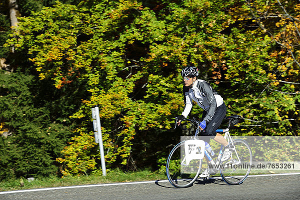 Cyclist riding along the Obersalzbergstrasse  Berchtesgaden  Upper Bavaria  Bavaria  Germany  Europe