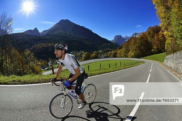 Cyclist riding along the Hochalpenstrasse  a high alpine road between Bischofswiesen and Berchtesgaden  Upper Bavaria  Bavaria  Germany  Europe