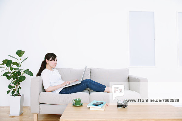 Woman using laptop on the sofa