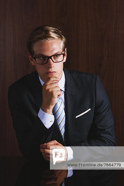 Businessman with glasses looking away