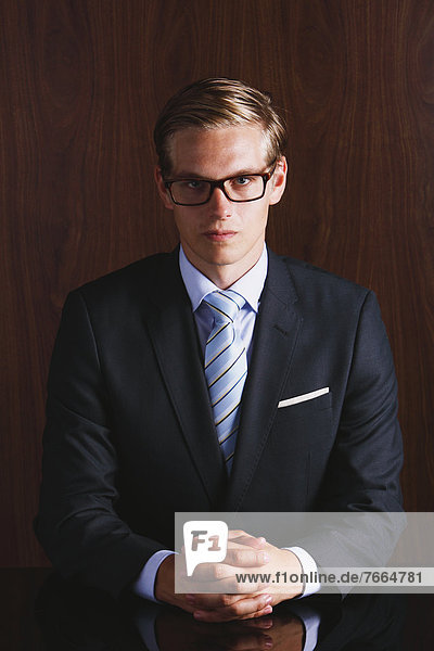 Businessman with glasses looking at camera