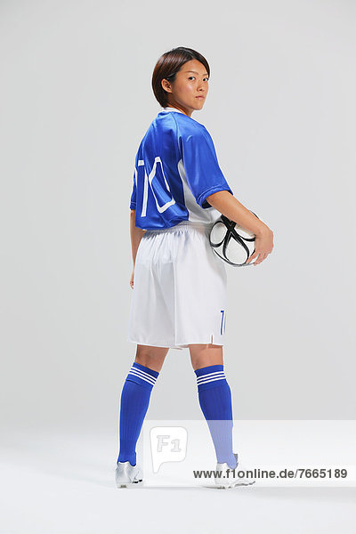 Woman In Soccer Uniform Posing With Ball