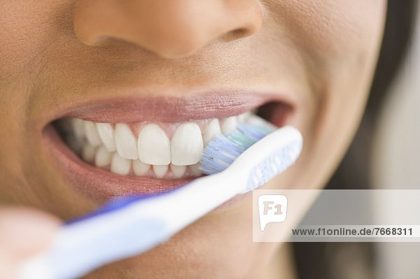 Close-up of woman brushing teeth