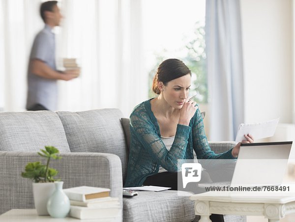 Woman using laptop to pay bills