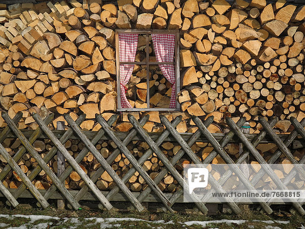 Fake windows in a stack of firewood  Isny  Allgaeu  Germany  Europe