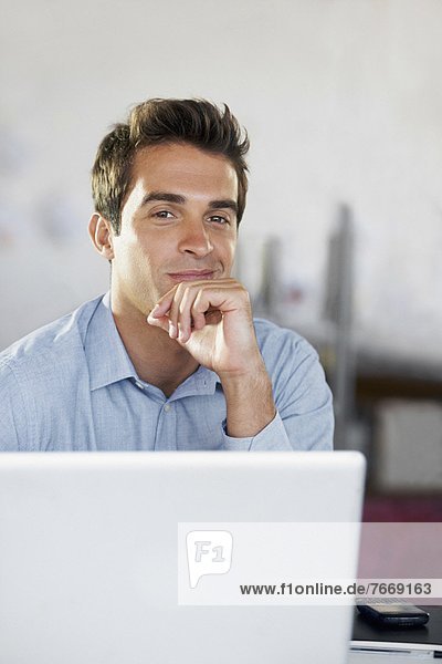 Portrait of man with laptop