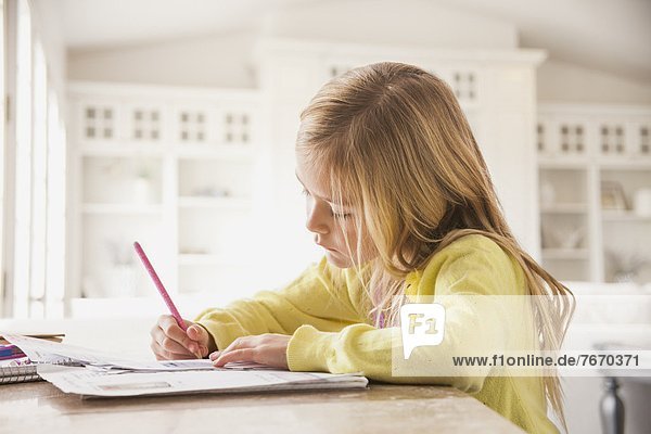 Girl (6-7) doing homework