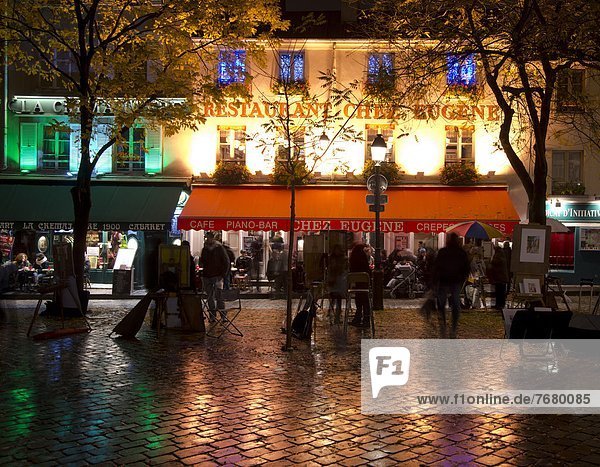 Restaurants and cafes lit at night in the Montmartre area of Paris  France  Europe