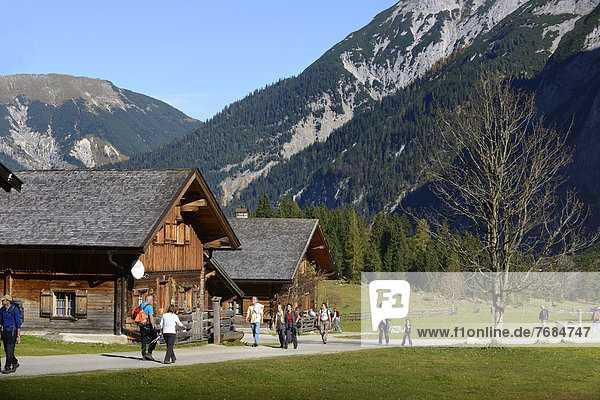 Hikers at Eng  Alpine cabins or chalets  Eng Alm  Grosser Ahornboden  alpine pasture with sycamore maple trees  Karwendel Mountains  Risstal Valley  Tyrol  Austria  Europe  PublicGround