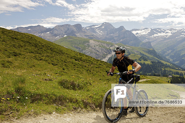 Mountain biker in the Alps near Lauenen  Canton Bern  Switzerland  Europe