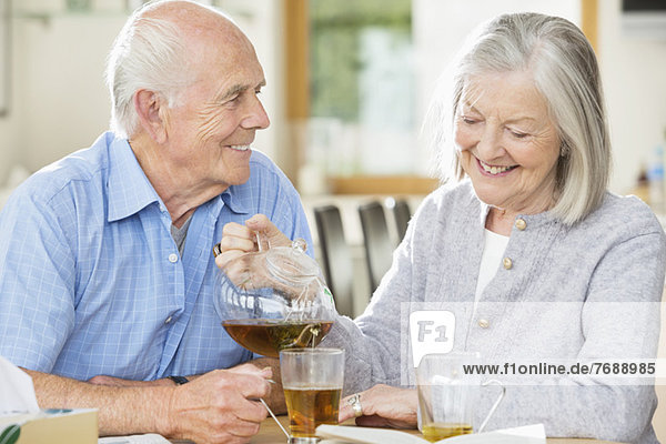 Older couple having tea together indoors