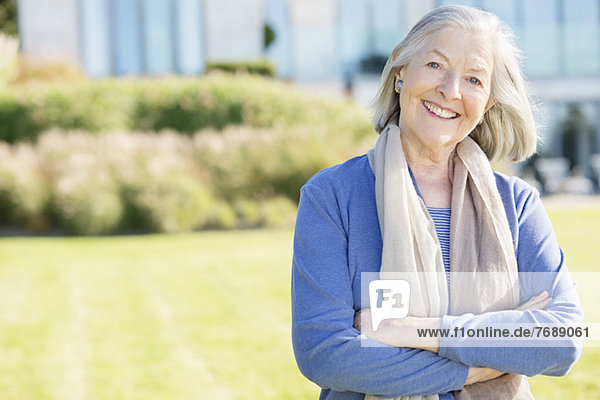 Smiling older woman standing outdoors