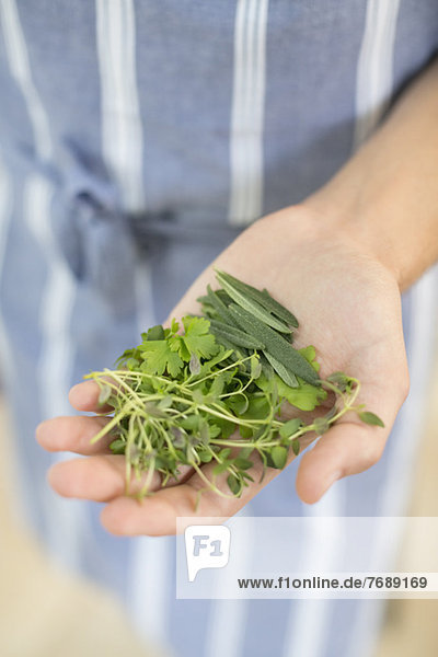 Woman holding handful of herbs