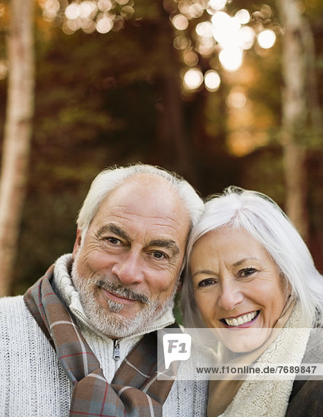 Older couple smiling together in park
