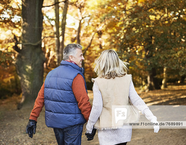 Older couple walking together in park