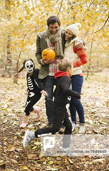 Couple with children in skeleton costumes in park