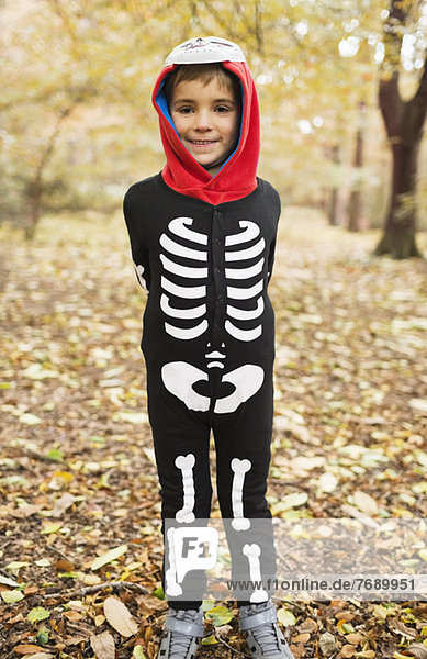 Boy wearing skeleton costume in park