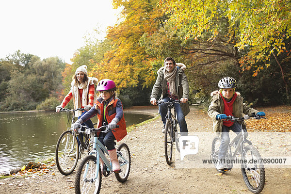 Family riding bicycles in park