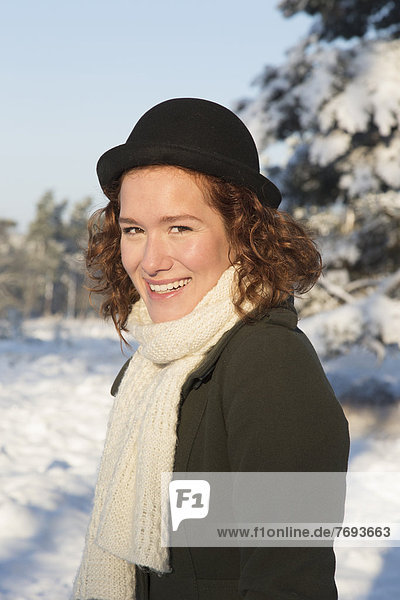 Caucasian woman smiling in snow
