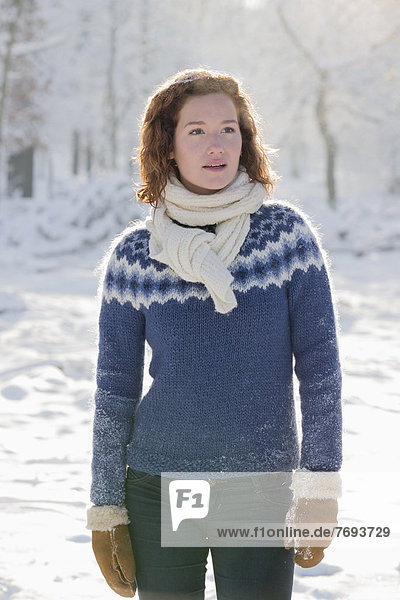 Caucasian woman standing in snow