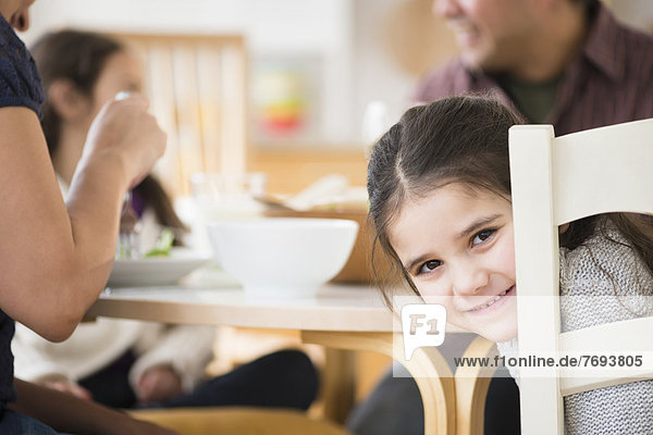 Smiling girl sitting at table