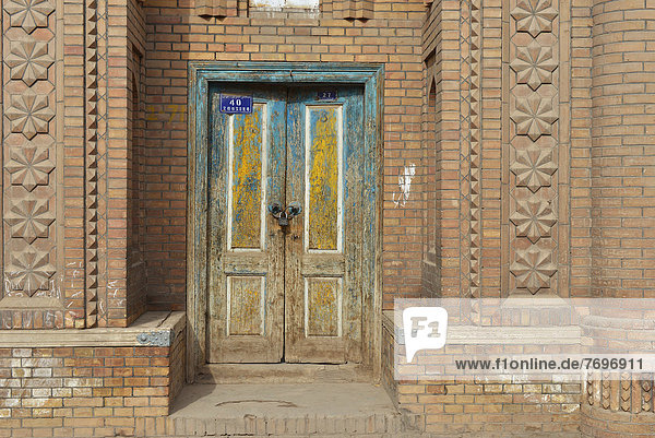Brightly painted old wooden door  Uyghur Muslim Quarter