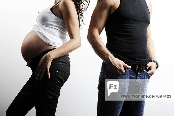 Woman with a pregnant belly  man standing next to her