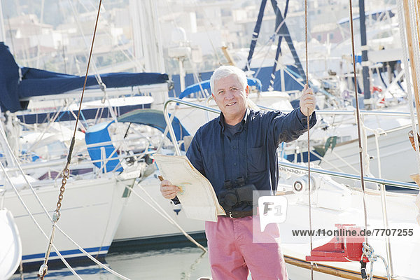 Older man standing on boat