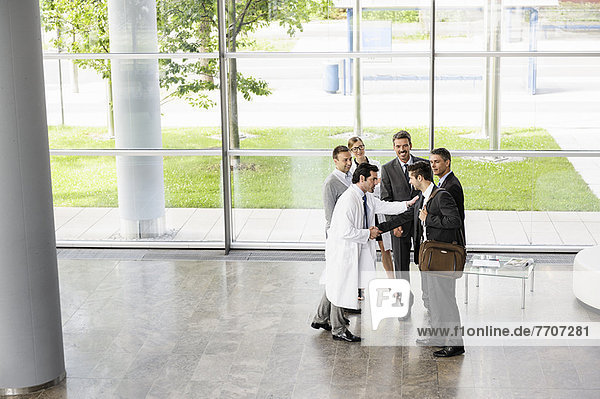 Business people and doctors greeting