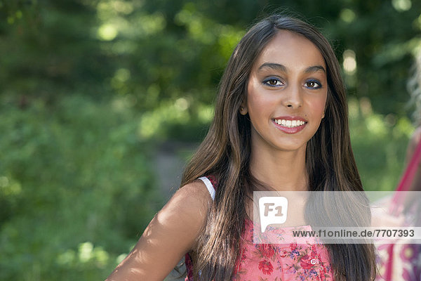 Teenage girl smiling outdoors