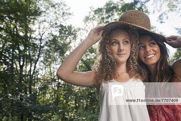 Teenage girls wearing straw hat outdoors