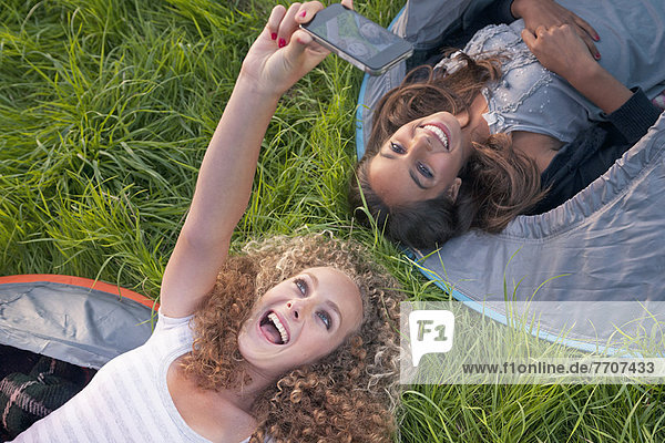 Jugendliche Mädchen beim Fotografieren auf dem Campingplatz