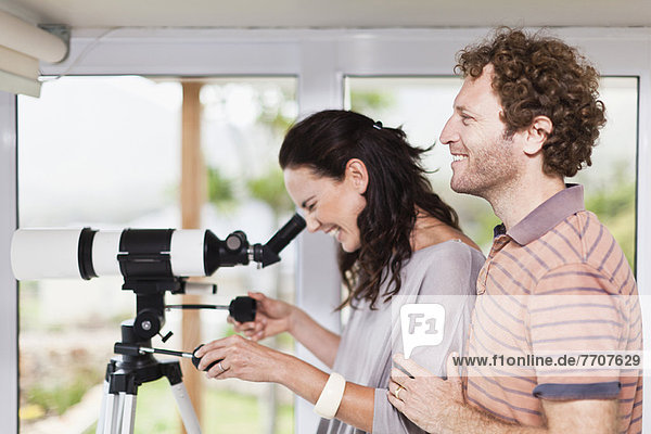 Woman using boyfriends telescope